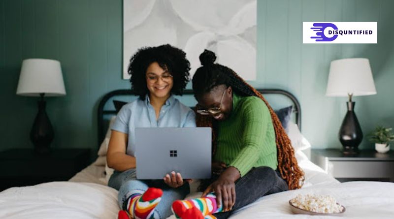 Two women, engaged with a laptop, focusing on improving self-service content quality and relevance.