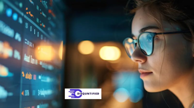 A woman with glasses focused on a computer screen, exploring self-service knowledge bases to enhance customer experience.